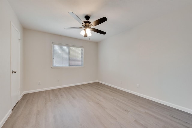unfurnished room with baseboards, light wood finished floors, and a ceiling fan