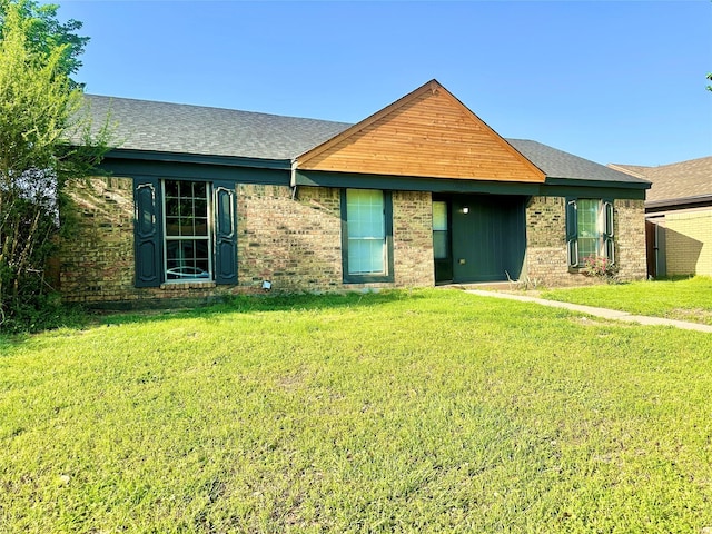 10035 Everton Pl, Dallas, TX 75217 - view of front of home with a shingled roof, brick siding, and a front lawn