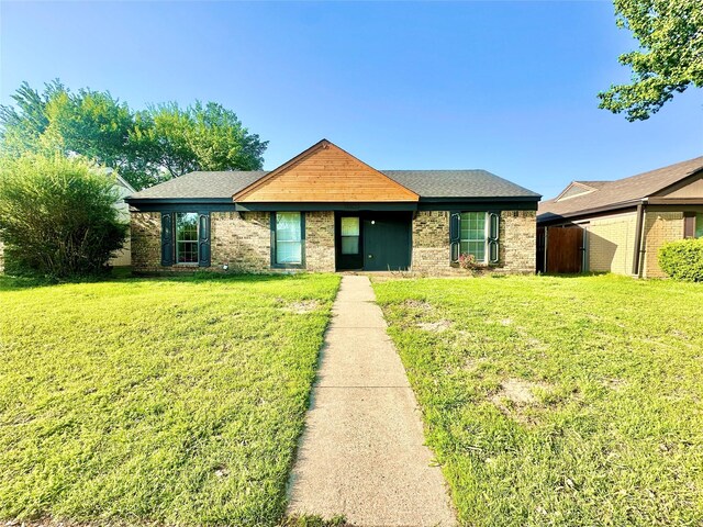 10035 Everton Pl, Dallas, TX 75217 - view of front facade with a front yard and brick siding