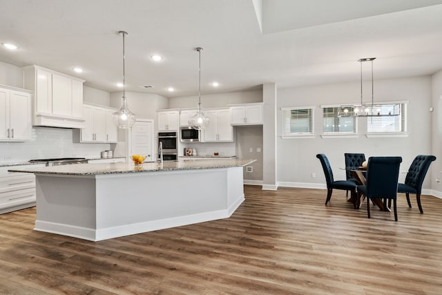 kitchen featuring appliances with stainless steel finishes, baseboards, white cabinetry, and recessed lighting