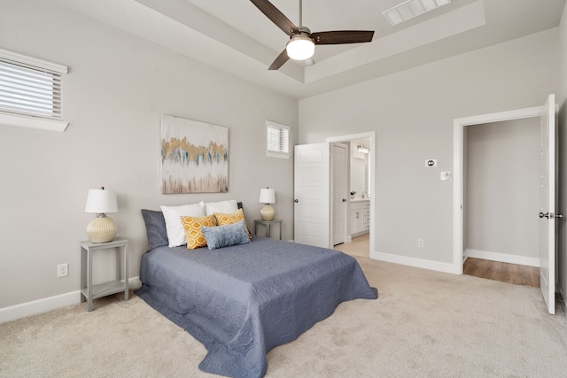 bedroom featuring visible vents, baseboards, ceiling fan, carpet, and connected bathroom