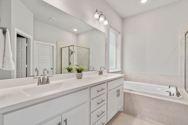 full bathroom with a sink, a shower stall, double vanity, and a garden tub