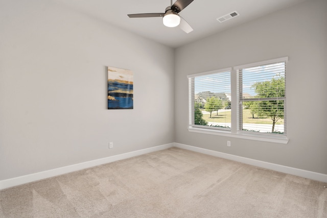 unfurnished room featuring light carpet, a healthy amount of sunlight, and visible vents