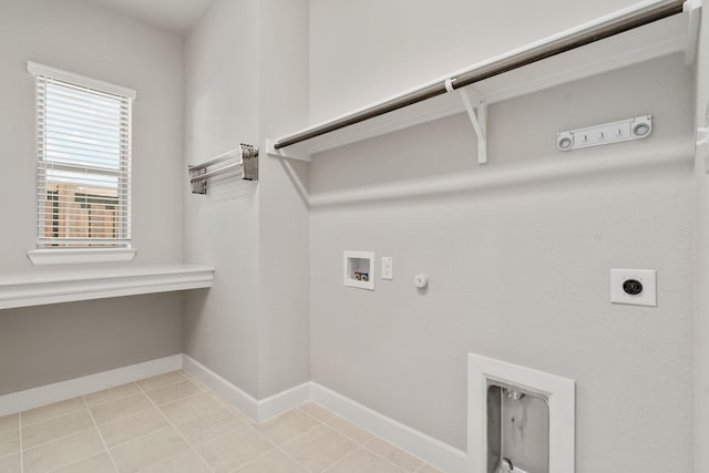laundry area with baseboards, washer hookup, laundry area, gas dryer hookup, and electric dryer hookup