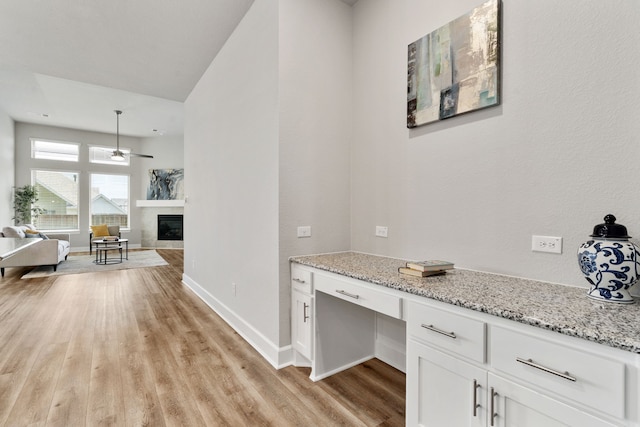 hallway with light wood-style flooring and baseboards