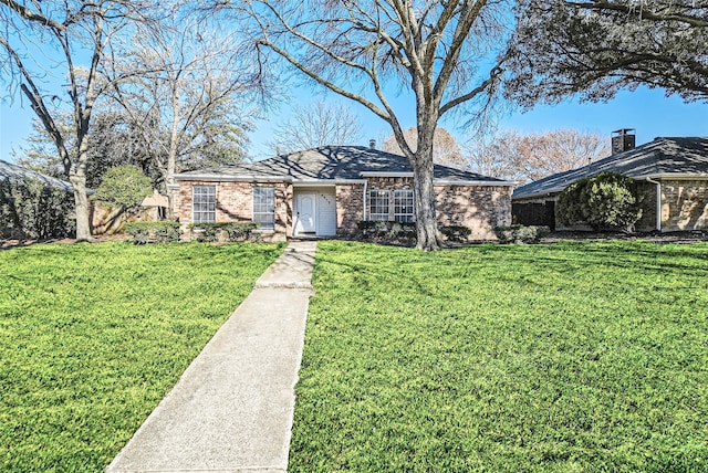 ranch-style house with a front lawn