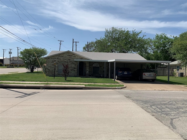 824 Opal St, Saginaw, TX 76179 - ranch-style house featuring concrete driveway, a carport, fence, and a front yard