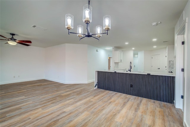 2023 Lake Trail Dr, Heartland, TX 75126 - kitchen featuring visible vents, baseboards, open floor plan, light wood-type flooring, and ceiling fan with notable chandelier