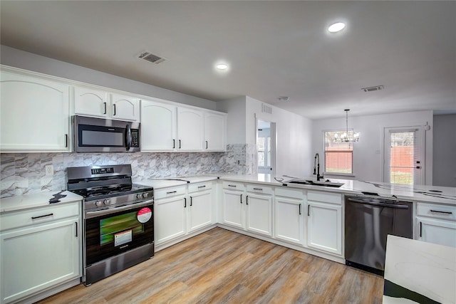 2023 Lake Trail Dr, Heartland, TX 75126 - kitchen with visible vents, an inviting chandelier, a sink, a wealth of natural light, and stainless steel appliances