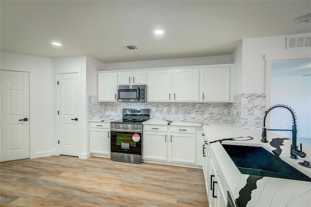 2023 Lake Trail Dr, Heartland, TX 75126 - kitchen featuring stainless steel appliances, light stone countertops, visible vents, and a sink