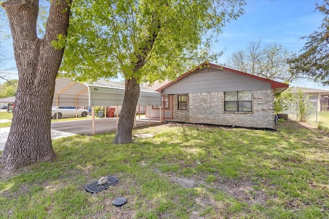 single story home featuring a carport, a front lawn, and brick siding