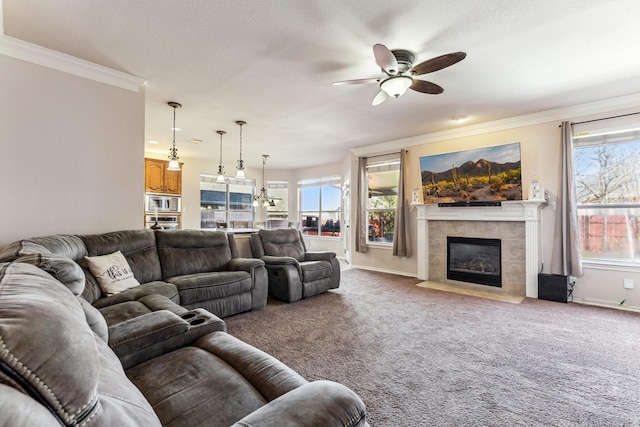 4745 Eagle Trace Dr, Fort Worth, TX 76244 - carpeted living room with ceiling fan, a tiled fireplace, crown molding, healthy amount of natural light, and baseboards