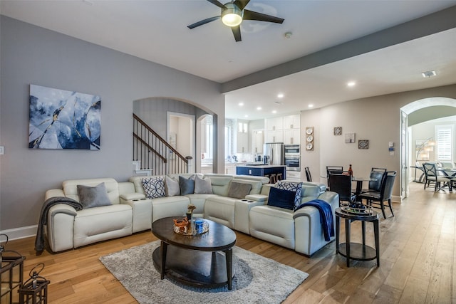 1638 Sandia Ln, Frisco, TX 75033 - living area featuring arched walkways, a ceiling fan, light wood finished floors, recessed lighting, and stairway