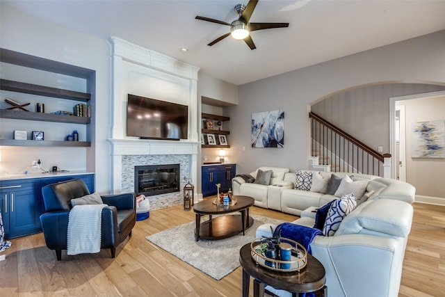1638 Sandia Ln, Frisco, TX 75033 - living area with ceiling fan, light wood-type flooring, stairway, and arched walkways