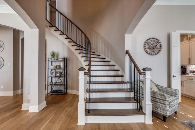 1638 Sandia Ln, Frisco, TX 75033 - stairs featuring arched walkways, a towering ceiling, and wood-type flooring