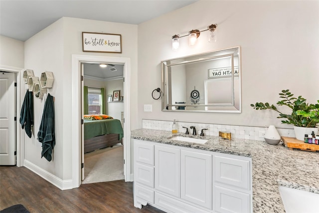 7423 Morning Glory Rd, Abilene, TX 79602 - ensuite bathroom featuring wood finished floors, vanity, and baseboards