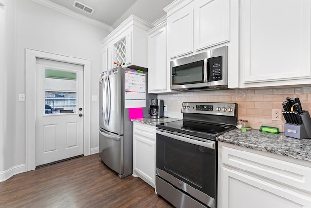 7423 Morning Glory Rd, Abilene, TX 79602 - kitchen featuring appliances with stainless steel finishes, decorative backsplash, white cabinetry, and ornamental molding
