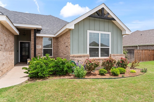 7423 Morning Glory Rd, Abilene, TX 79602 - view of exterior entry with brick siding, board and batten siding, and roof with shingles