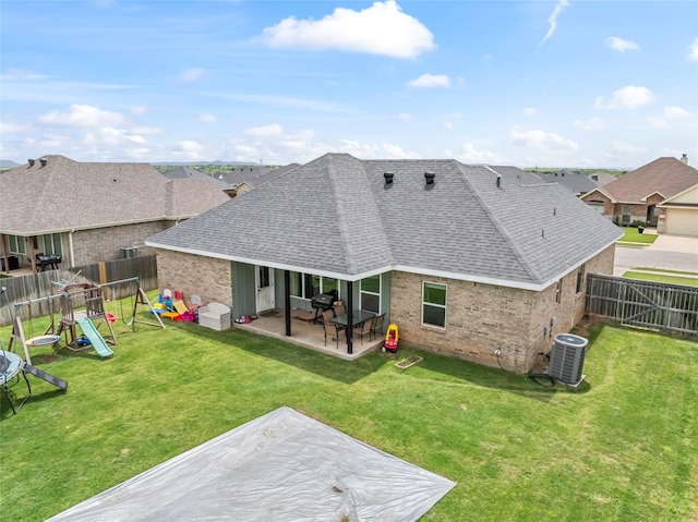 7423 Morning Glory Rd, Abilene, TX 79602 - back of house with a patio area, a shingled roof, brick siding, a playground, and a residential view