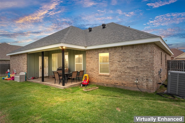 7423 Morning Glory Rd, Abilene, TX 79602 - back of property at dusk featuring a shingled roof, a patio area, central AC, and brick siding