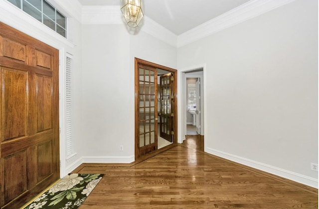824 Parkwood Ct, Mckinney, TX 75072 - foyer entrance with crown molding, wood finished floors, and baseboards