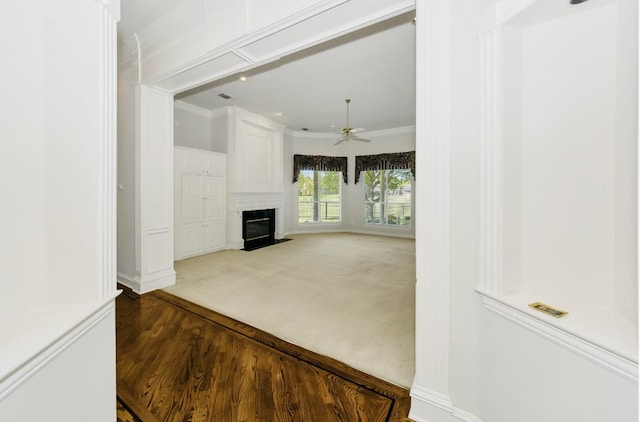 824 Parkwood Ct, Mckinney, TX 75072 - unfurnished living room featuring a fireplace with flush hearth, a ceiling fan, crown molding, baseboards, and wood finished floors