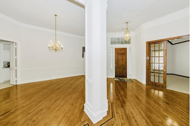 824 Parkwood Ct, Mckinney, TX 75072 - entrance foyer with crown molding, wood finished floors, a chandelier, and baseboards