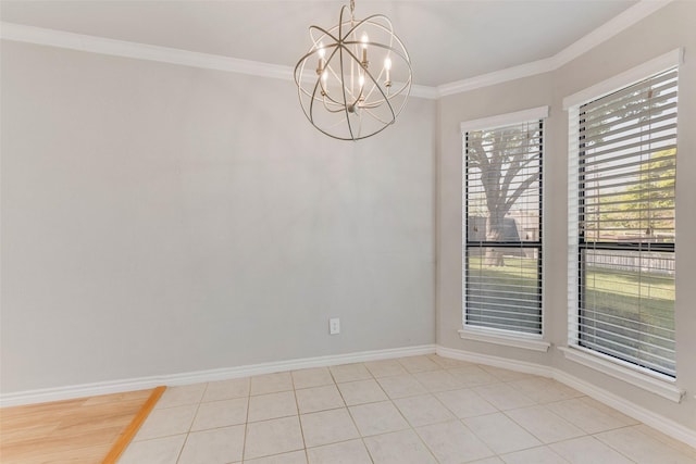unfurnished dining area with a chandelier, crown molding, and baseboards