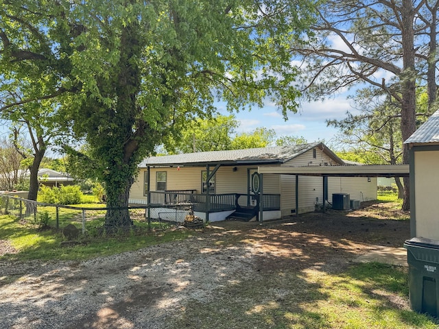 281 Seminole Dr, Gordonville, TX 76245 - view of front of house featuring central AC unit, driveway, a carport, and fence