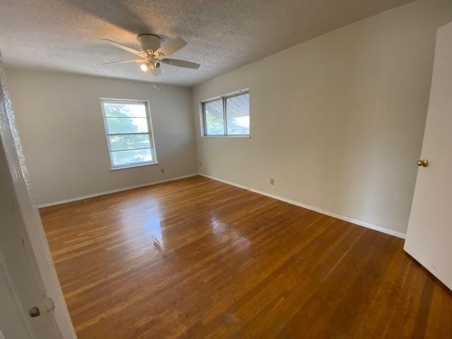 4219 Parkwood Dr, San Antonio, TX 78218 - unfurnished room featuring ceiling fan, a textured ceiling, baseboards, and wood finished floors