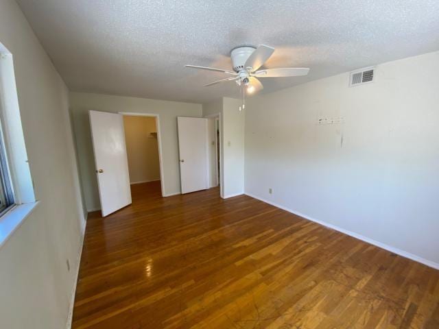 4219 Parkwood Dr, San Antonio, TX 78218 - unfurnished bedroom featuring ceiling fan, a spacious closet, visible vents, wood finished floors, and baseboards