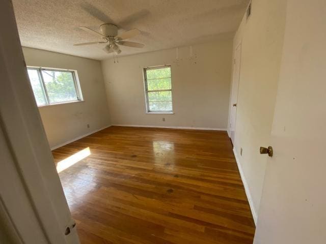 4219 Parkwood Dr, San Antonio, TX 78218 - unfurnished room with wood-type flooring, ceiling fan, plenty of natural light, and a textured ceiling