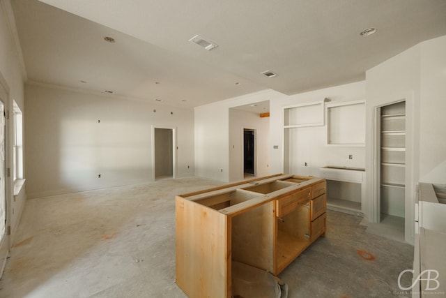1206 Lytle Acres Dr, Abilene, TX 79602 - kitchen featuring unfinished concrete floors, a kitchen island, and ornamental molding