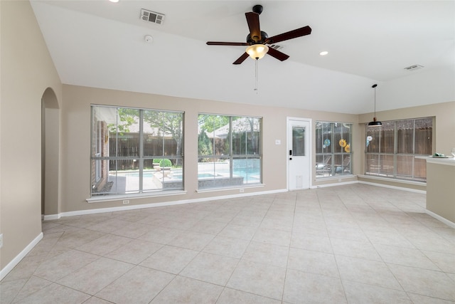 unfurnished room featuring visible vents, ceiling fan, arched walkways, and vaulted ceiling