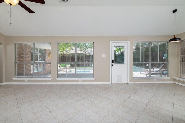 spare room with tile patterned floors, baseboards, a ceiling fan, and lofted ceiling