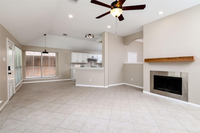 unfurnished living room featuring visible vents, light tile patterned floors, a ceiling fan, a fireplace, and lofted ceiling