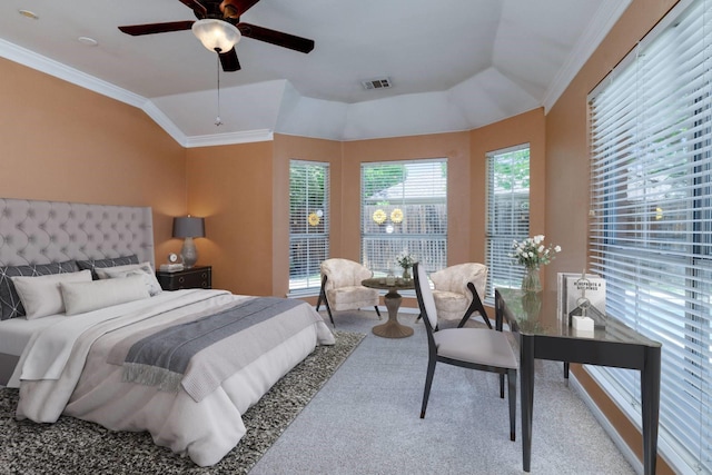 carpeted bedroom with a ceiling fan, lofted ceiling, ornamental molding, and visible vents