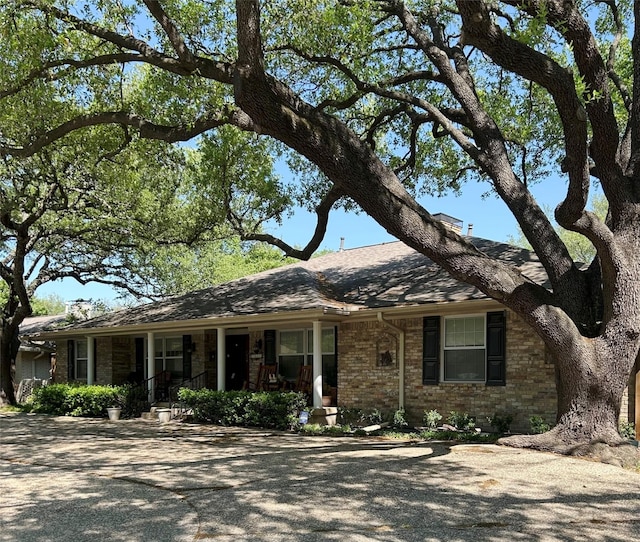 7261 Ashington Dr, Dallas, TX 75225 - single story home with brick siding, covered porch, and roof with shingles