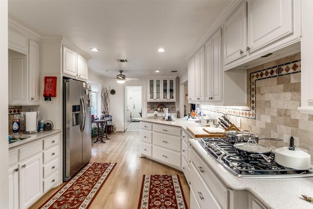 7261 Ashington Dr, Dallas, TX 75225 - kitchen with appliances with stainless steel finishes, ceiling fan, white cabinets, recessed lighting, and light countertops