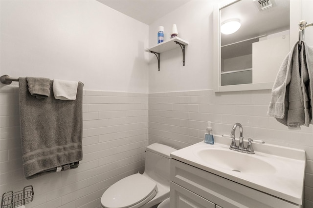 7261 Ashington Dr, Dallas, TX 75225 - bathroom with tile walls, toilet, vanity, and wainscoting