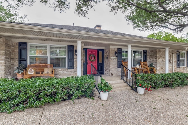 7261 Ashington Dr, Dallas, TX 75225 - view of front of house with covered porch, brick siding, a chimney, and a shingled roof