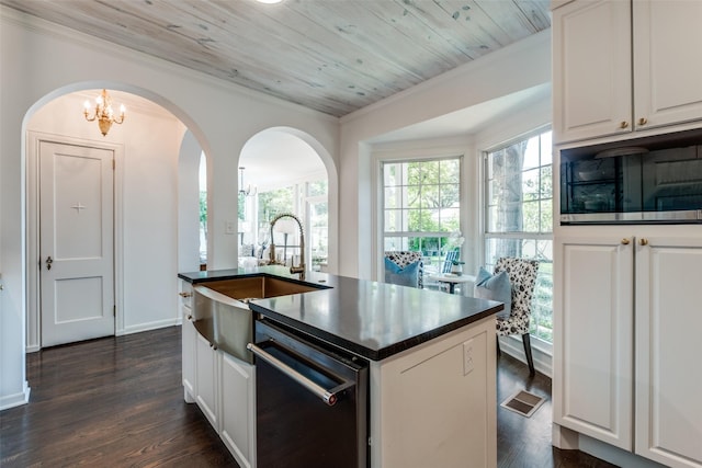 4661 Mockingbird Ln, Highland Park, TX 75209 - kitchen featuring dishwasher, dark countertops, a sink, arched walkways, and a chandelier