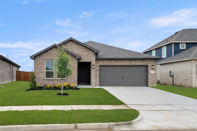single story home featuring driveway, a garage, brick siding, fence, and a front lawn