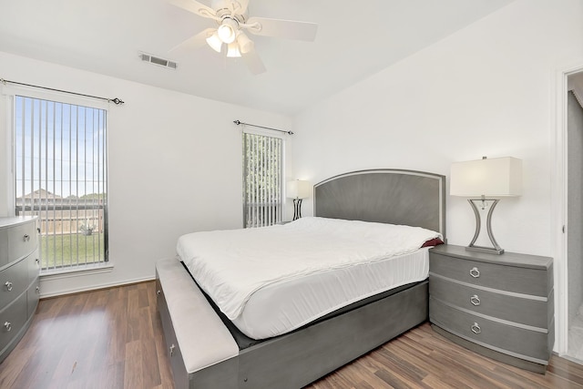 bedroom featuring dark wood-type flooring, visible vents, and multiple windows