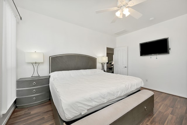 bedroom featuring dark wood-style flooring, visible vents, and ceiling fan