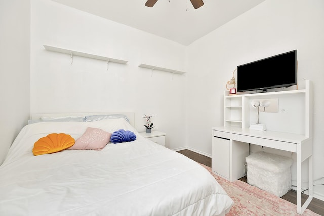 bedroom featuring baseboards, a ceiling fan, and wood finished floors