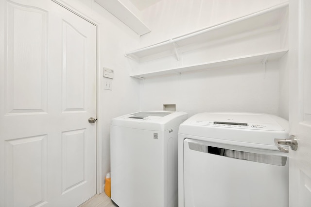 laundry room with washing machine and clothes dryer and laundry area