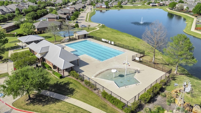 drone / aerial view featuring a water view and a residential view