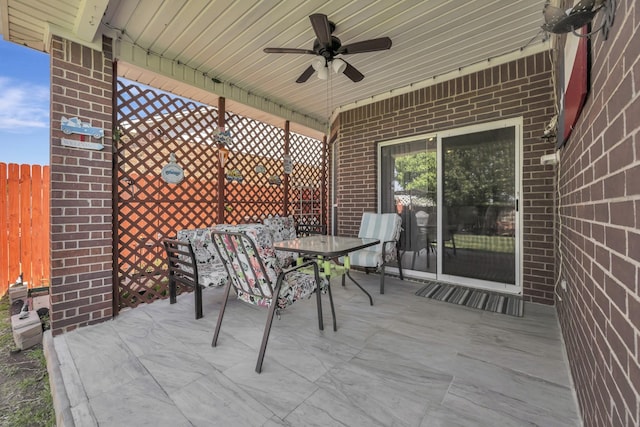view of patio / terrace with ceiling fan, fence, and outdoor dining area