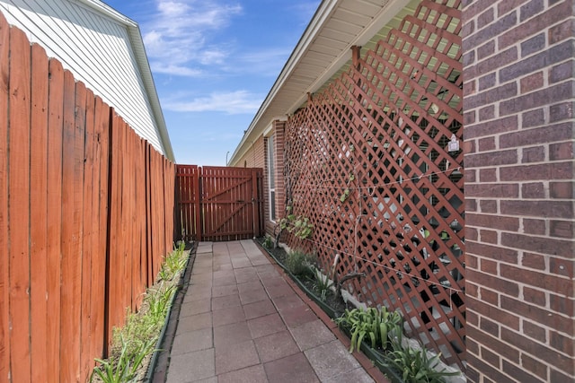 view of property exterior featuring fence and a gate